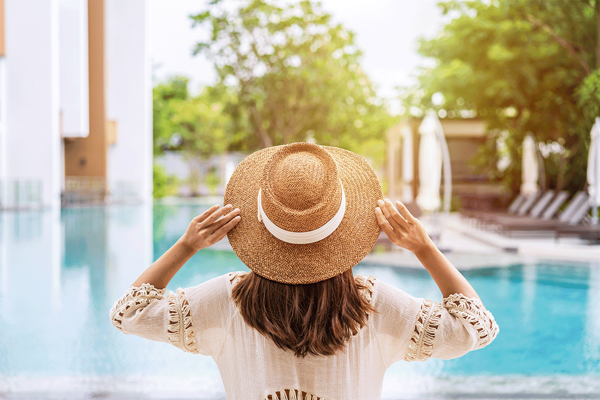 Woman wearing a sunhat standing in front of a pool, Go to How a Resort Casino Increased Room Bookings with Native & CTV Advertising