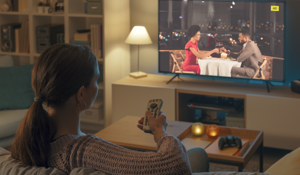 Woman watching TV in the evening